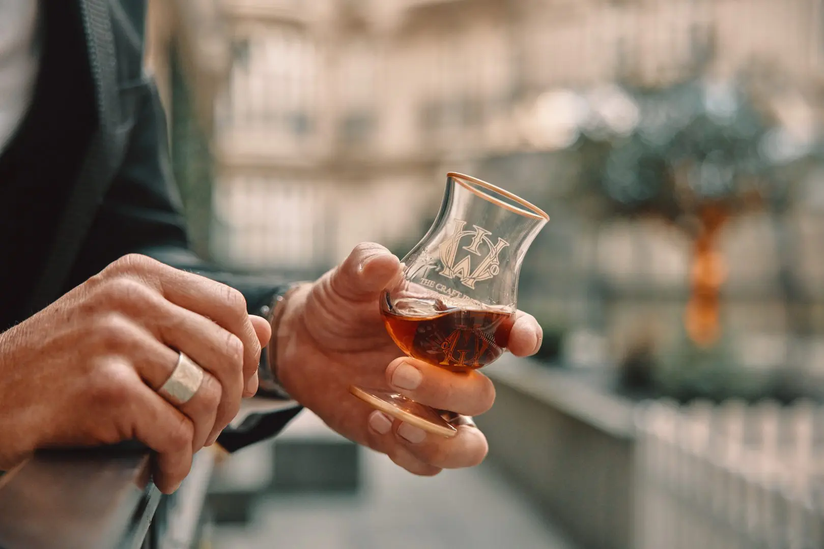 person holding a glass of collectable whiskey