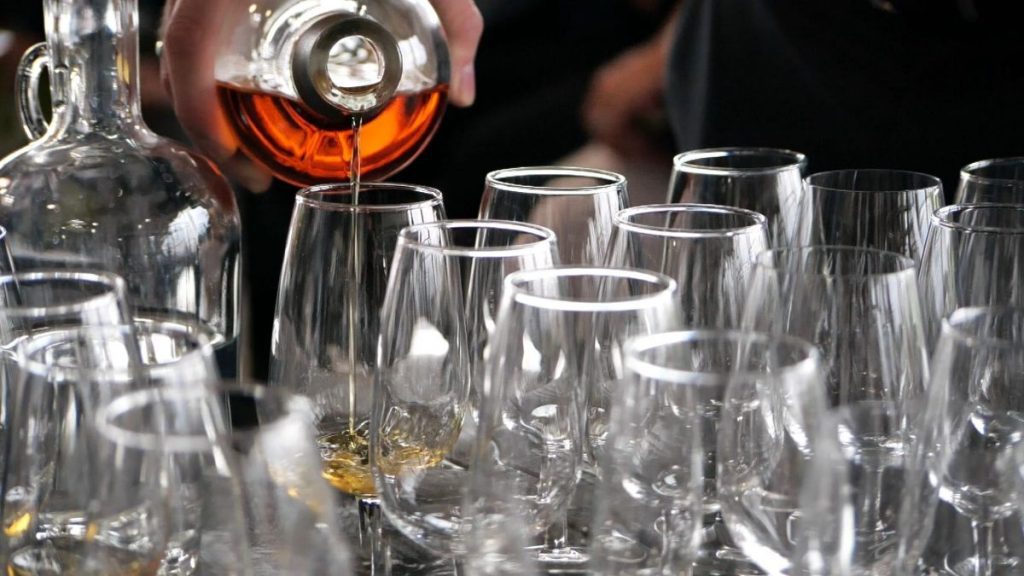 Pouring luxury rare whiskey into glasses