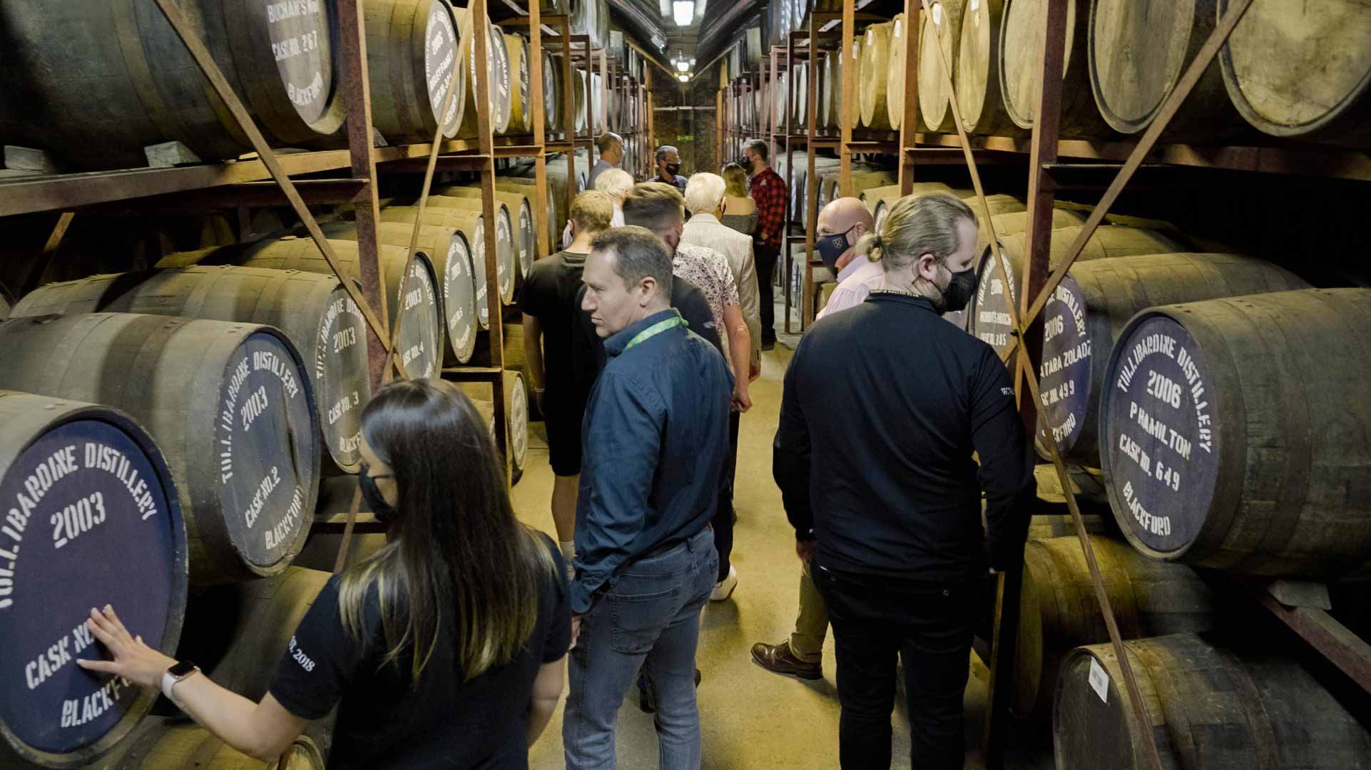 A group of people on a tour of the Tullibardine Distillery